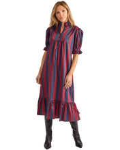 Woman wearing a red and blue striped dress on a white background