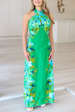 Woman wearing a green floral dress in an indoor setting